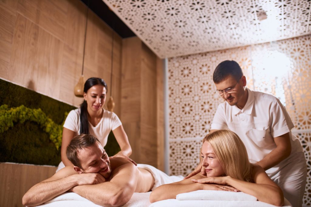 couples massage with couple chatting