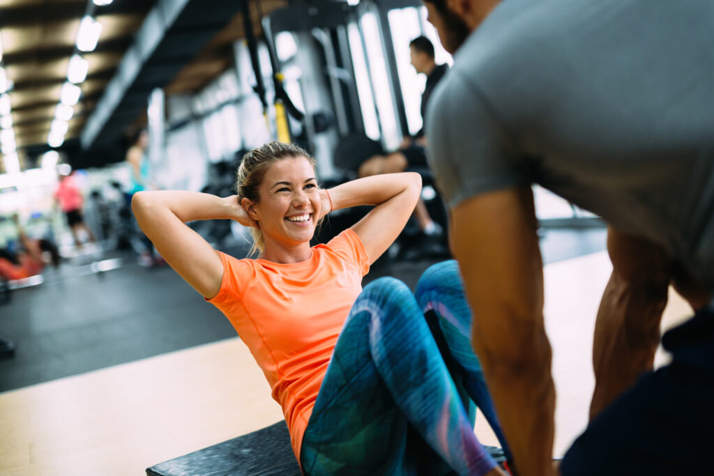 Woman doing exercises with personal trainer