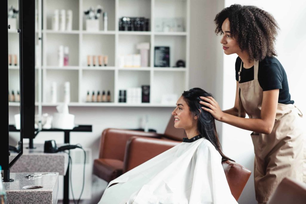 young woman getting hair styling consult