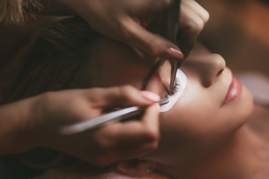 eye lash extensions being applied