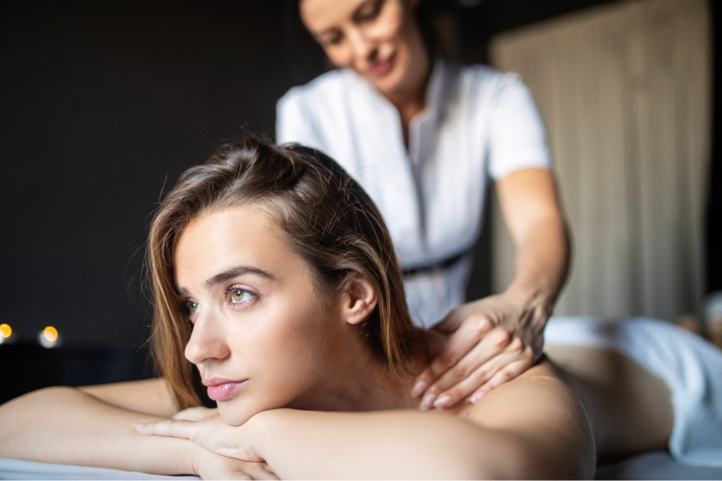 massage therapist giving girl swedish massage
