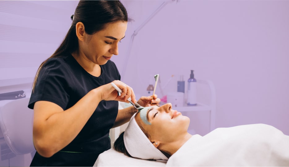 esthetician applying face serum