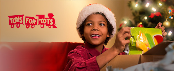 boy opening up a toy for christmas