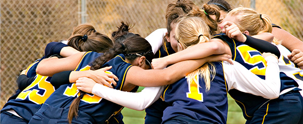 girls team in a huddle