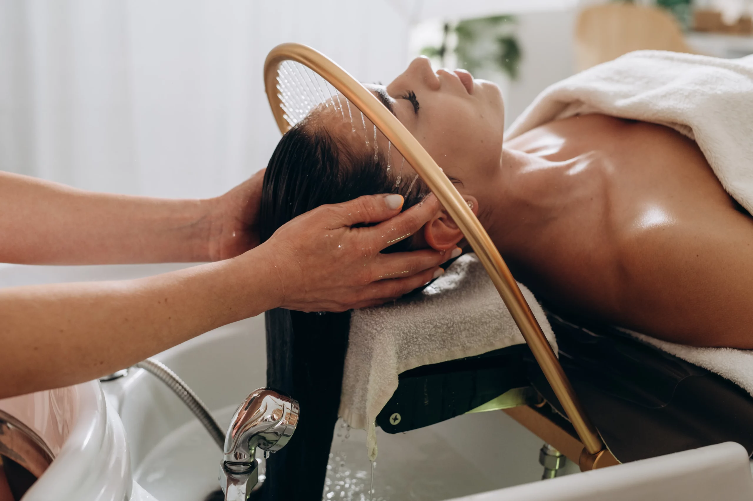 Client receiving scalp wash and massage services