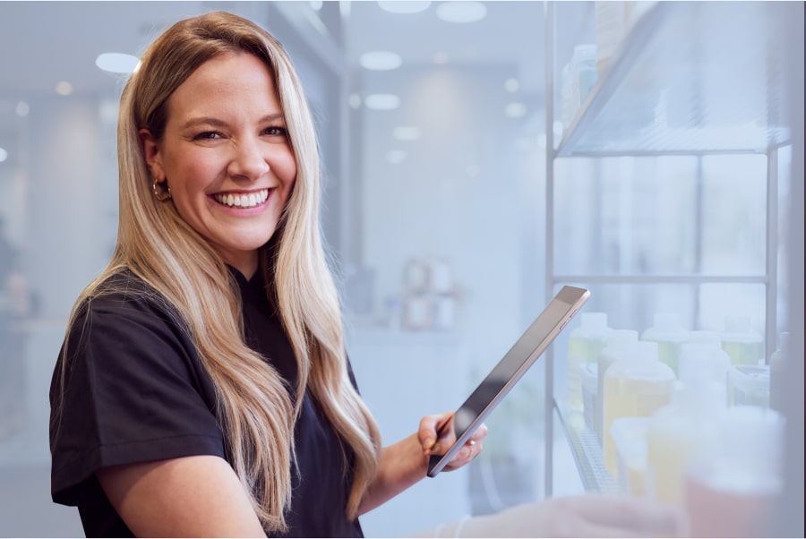 salon and spa owner on tablet smiling