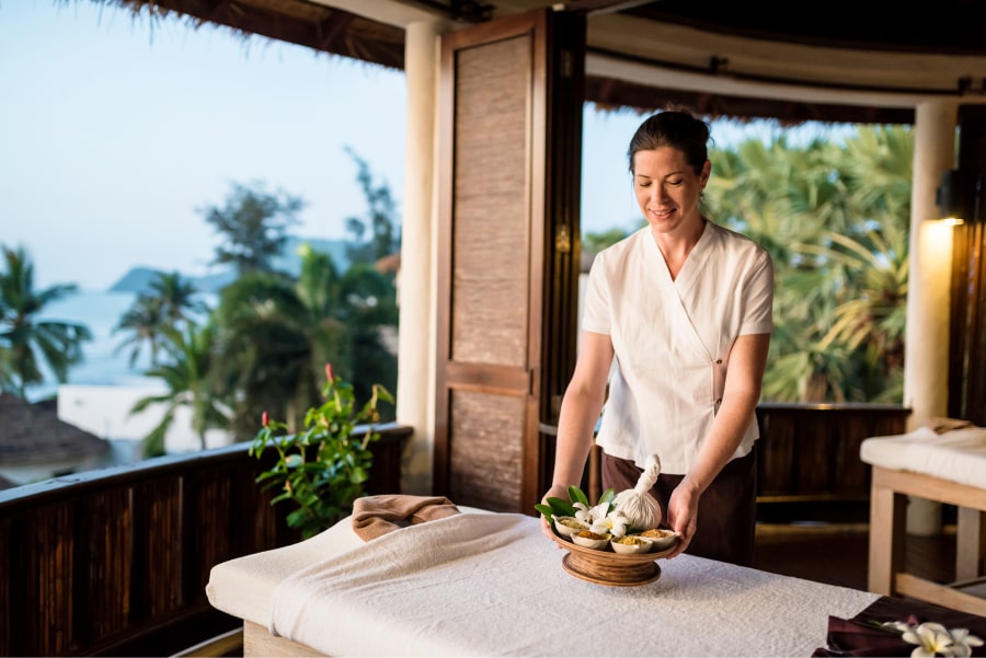 woman arranging elements on massage table