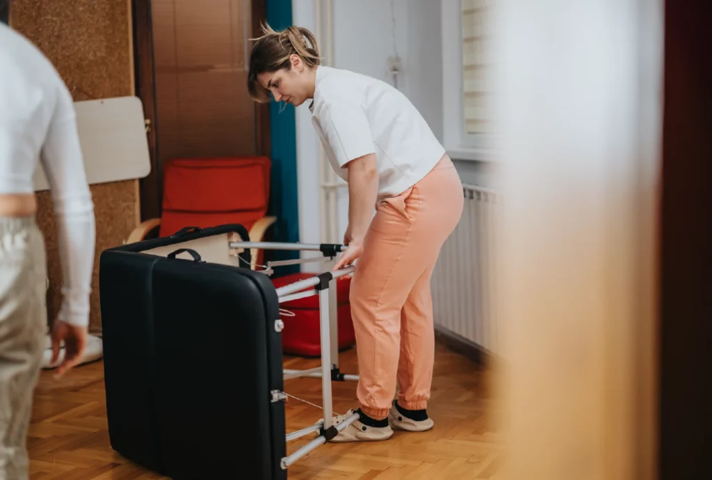 a massage therapist setting up her massage table