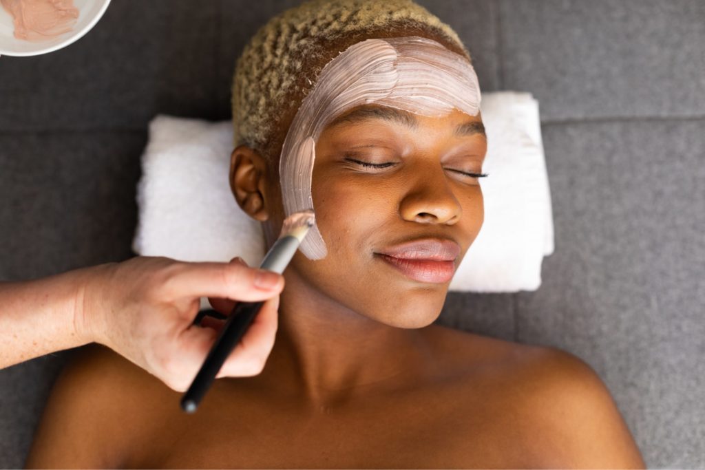 woman getting face mask applied