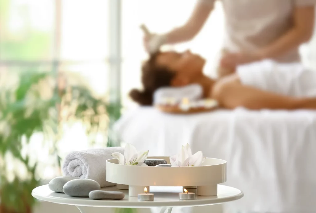 A blurred woman receiving a facial massage