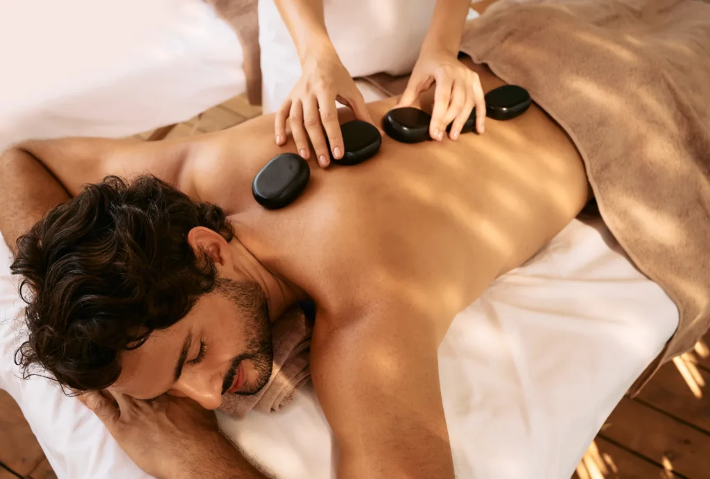 A man receiving a hot stone massage.