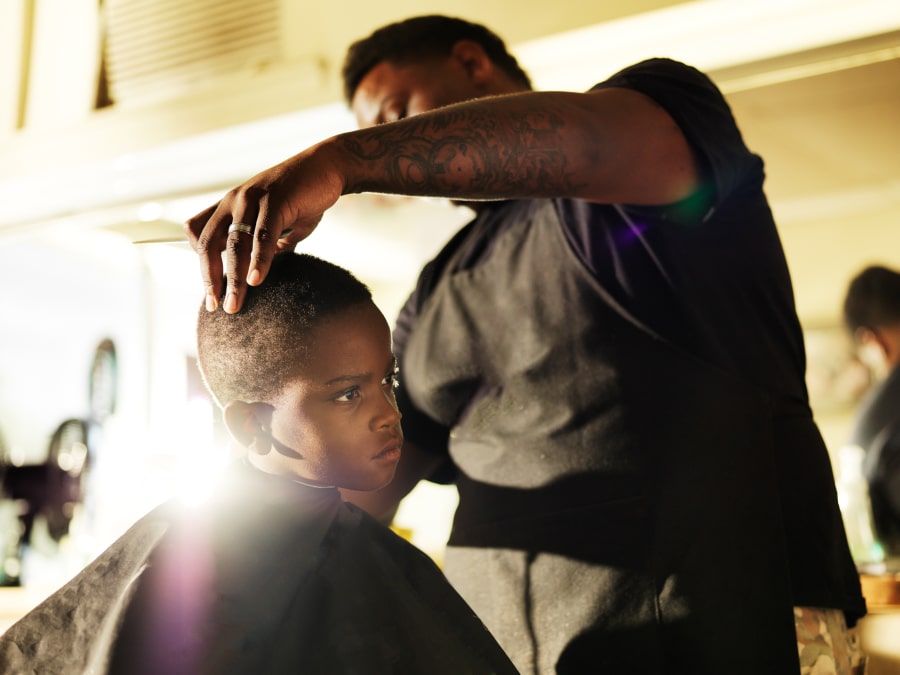 small kid getting haircut at barbers