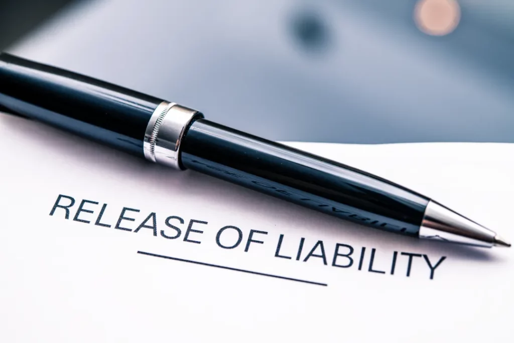 A paper that reads, "Release of Liability" with a black and silver pen resting atop it.