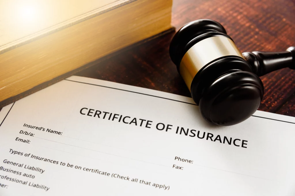 A partial example of a blank certificate of insurance on a desk with a gavel and book.