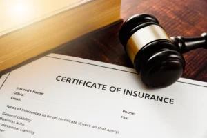 A partial example of a blank certificate of insurance on a desk with a gavel and book.