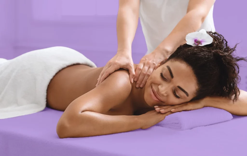 woman getting massage with flower in her hair