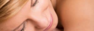 close up of womans face while getting a massage