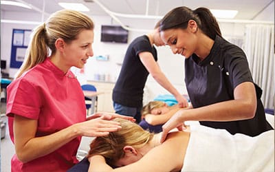 massage therapist student practicing in class