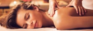 woman laying on massage table getting shoulder massaged