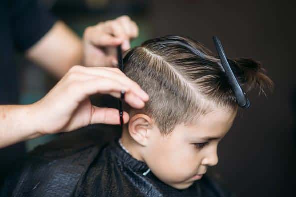boy getting a haircut at hair salon