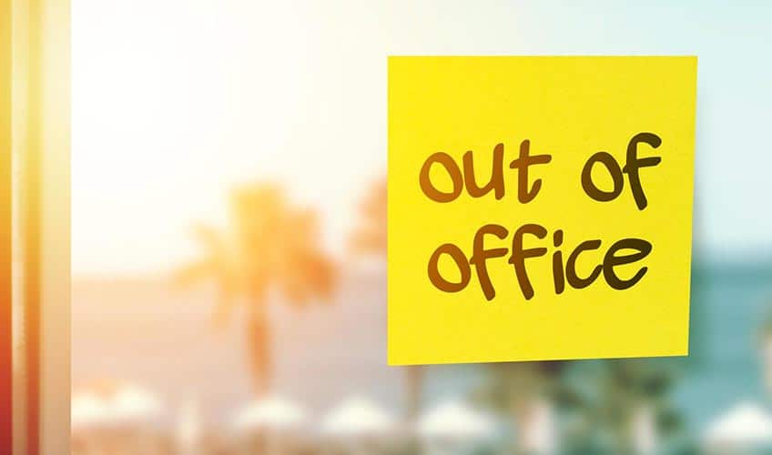 window with a post it note that says out of office