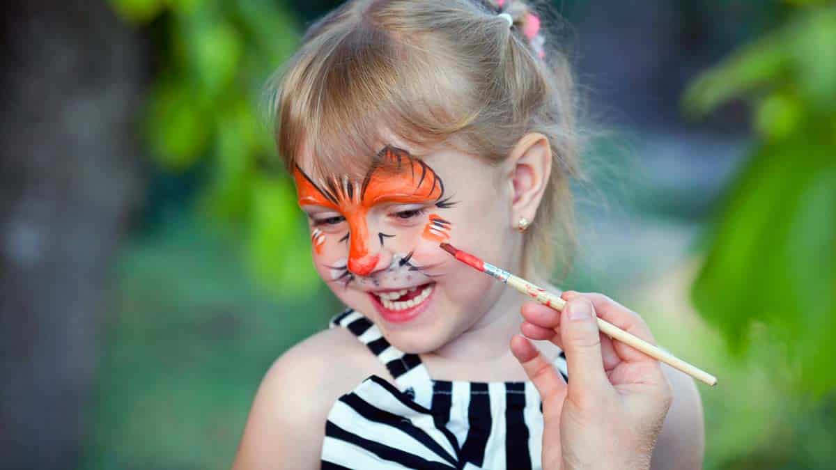 Little girl getting her face painted