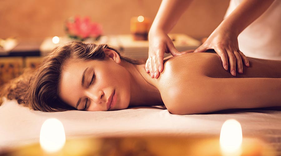 woman getting a back massage from massage therapist