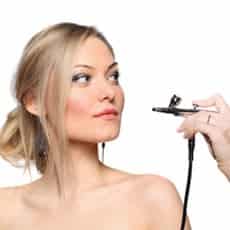 woman getting airbrush makeup done