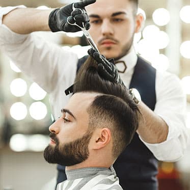 barber cutting mans hair