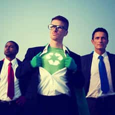 men with suits on and one opening his shirt showing recycle sign