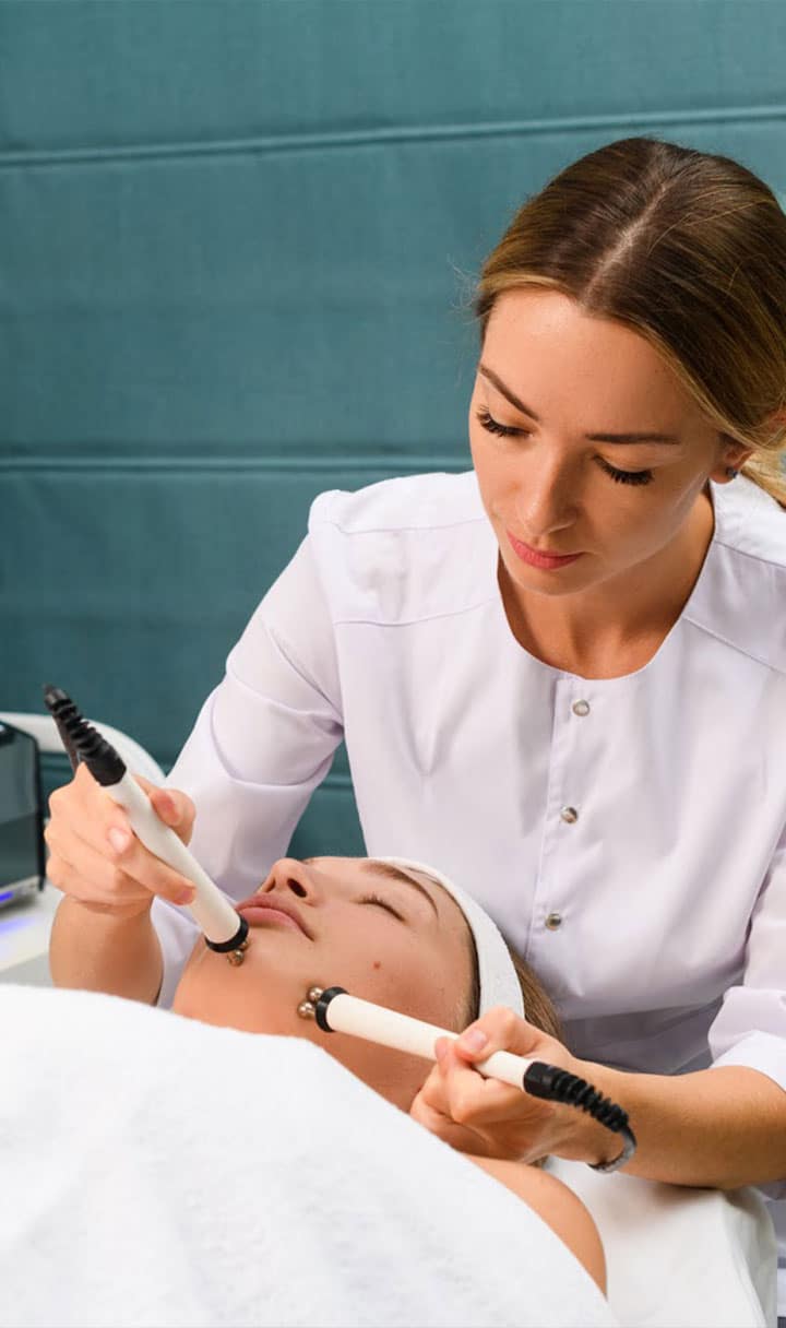esthetician gently using microdermabrasion tools on clients face