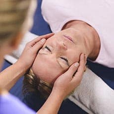 woman relaxing getting a healing touch treatment