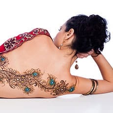 woman with large henna tattoo across back