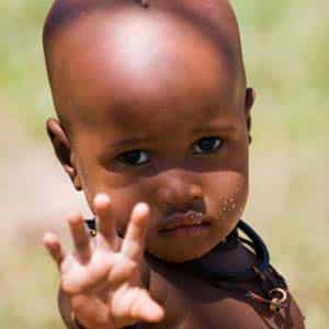 sad kenyan boy reaching out to camera