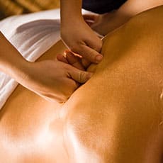 swedish massage therapist giving back massage