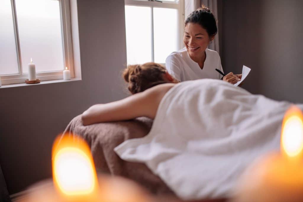 woman taking notes with massage client